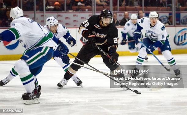 The Ducks' Mathieu Perreault maneuvers through a group of Canucks during their game at Honda Center in Anaheim on November 10, 2013.