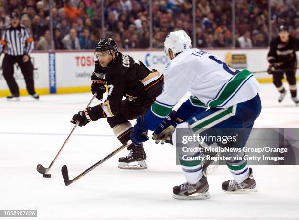 The Ducks' Andrew Cogliano gets past the Canucks' Christopher Tanev at Honda Center in Anaheim on November 10, 2013.