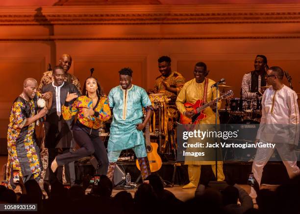 An unidentified audience member dances onstage with Senegalese singer and composer Youssou N'Dour and his band, le Super Etoile de Dakar, at Carnegie...