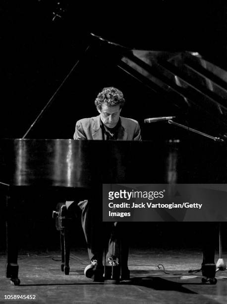 American composer Philip Glass plays piano as he performs during a benefit for the World Music Institute at Symphony Space, New York, New York, May...
