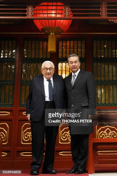 China's Foreign Minister Wang Yi meets former U.S. Secretary of State Henry Kissinger at the Diaoyutai State Guesthouse in Beijing on November 8,...