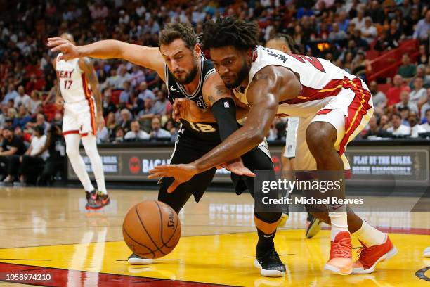 Justise Winslow of the Miami Heat and Marco Belinelli of the San Antonio Spurs battle for a loose ball during the first half at American Airlines...