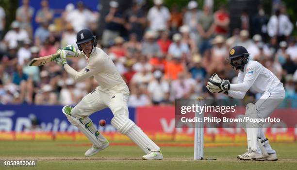 Keaton Jennings of England hits out watched by Niroshan Dickwella of Sri Lanka during the third day of the 1st Cricket Test Match between Sri Lanka...