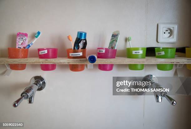 Plastic glasses containing the tooth brush and tooth paste are displayed in the bathroom at the welcome center's apartment part of the French...