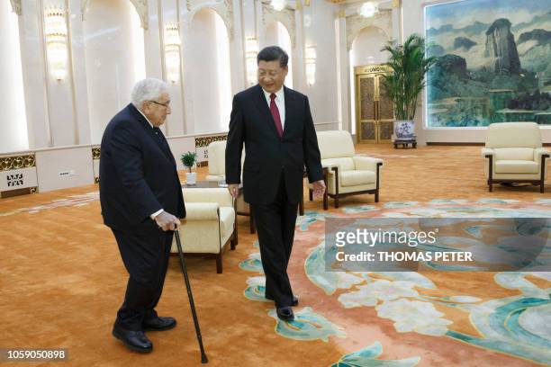 China's President Xi Jinping meets former US secretary of state Henry Kissinger at the Great Hall of the People in Beijing on November 8, 2018.