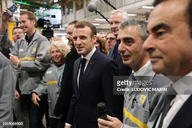 French President Emmanuel Macron arrives flanked by Chairman and CEO of Renault-Nissan-Mitsubishi Carlos Ghosn and followed by French Economy...