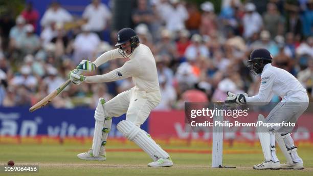 Keaton Jennings of England hits out watched by Niroshan Dickwella of Sri Lanka during the third day of the 1st Cricket Test Match between Sri Lanka...