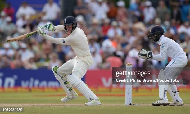 Keaton Jennings of England hits out watched by Niroshan Dickwella of Sri Lanka during the third day of the 1st Cricket Test Match between Sri Lanka...