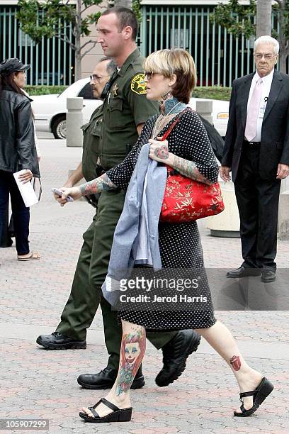 Janine Lindemulder is escorted into the Lamoreaux Justice Center by Orange County Sheriff Deputies after a confronting photographer on October 21,...
