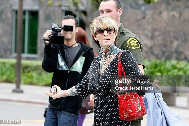 Janine Lindemulder is escorted into the Lamoreaux Justice Center by Orange County Sheriff Deputies after a confronting photographer on October 21,...