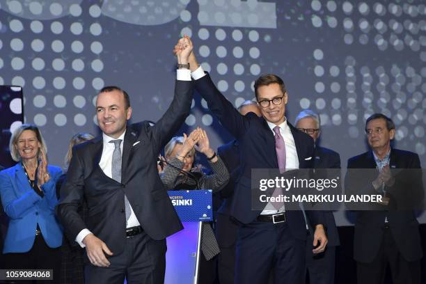 The top candidates of the European People's Party , Manfred Weber of Germany and Alexander Stubb of Finland raise their arms after the results of the...