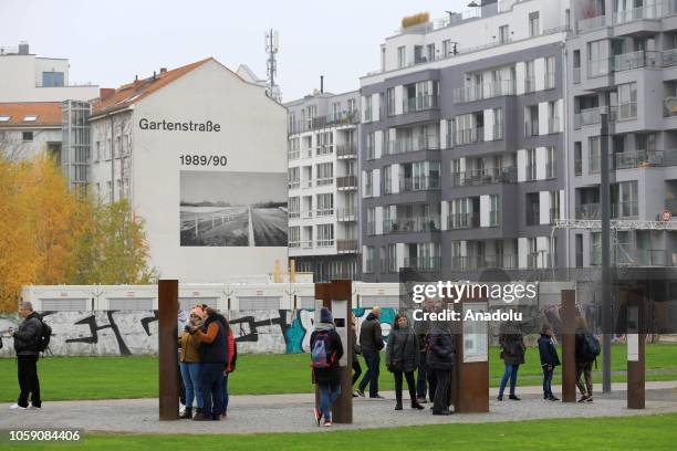 People visit the East Side Gallery on the 29th anniversary of the fall of the Berlin Wall in Berlin, Germany on November 8, 2018. Brandenburg Gate is...