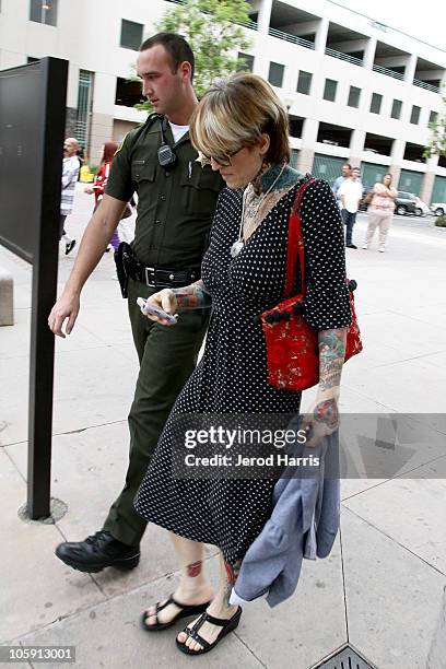 Janine Lindemulder is escorted into the Lamoreaux Justice Center by Orange County Sheriff Deputies after a confronting photographer on October 21,...