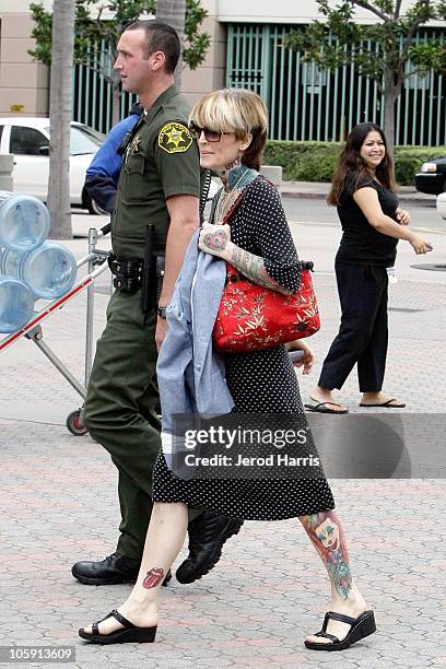 Janine Lindemulder is escorted into the Lamoreaux Justice Center by Orange County Sheriff Deputies after a confronting photographer on October 21,...