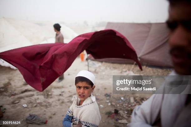 An Afghan boy, from Kapisa province, stands in a tent camp October 21, 2010 east of Kabul, Afghanistan. People from the restive Kapisa province have...