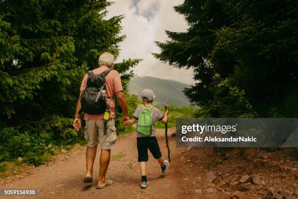 escursioni con mio nonno - family hiking in spring outdoors foto e immagini stock