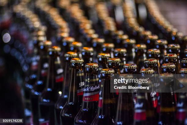 Capped and labelled bottles of Carling Black Label beer move along a conveyor belt on the production line at the SABMiller Plc Alrode brewery and...