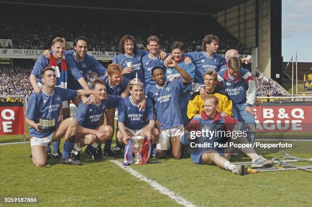 Members of the Rangers FC football team squad celebrate on the pitch with the trophy after beating Aberdeen 2-0 at Ibrox Stadium to win the 1990-91...