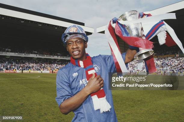 English professional footballer Mark Walters, midfielder with Rangers FC, celebrates with the trophy on the pitch after Rangers beat Aberdeen 2-0 at...