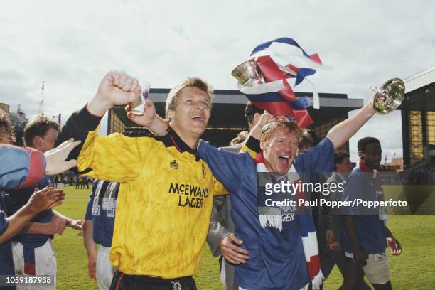 Goalkeeper Chris Woods and forward Mo Johnston of Rangers FC, celebrate with the trophy on the pitch after Rangers beat Aberdeen 2-0 at Ibrox Stadium...