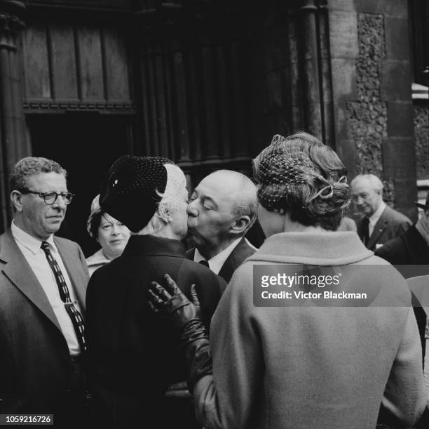 American composer Richard Rodgers kisses Australian interior designer and decorator Dorothy Hammerstein at a memorial service for her late husband...