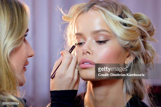 Frida Aasen prepares backstage during the 2018 Victoria's Secret Fashion Show in New York at Pier 94 on November 8, 2018 in New York City.