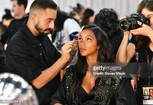 Model Lais Ribeiro prepares backstage for hair and makeup at 2018 Victoria's Secret Fashion Show at Pier 94 on November 8, 2018 in New York City.