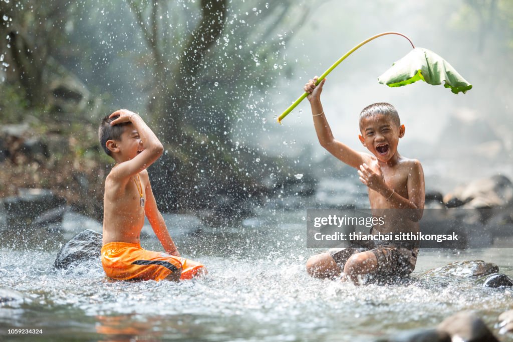 Kid enjoy playing splashing water