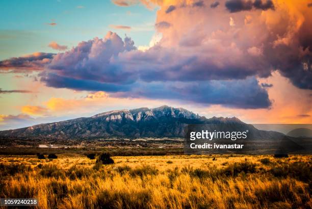 sandia mountains with majestic sky and clouds - new mexico mountains stock pictures, royalty-free photos & images