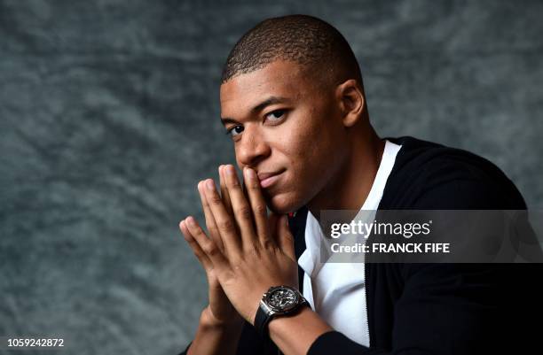 France's forward Kylian MBappe poses during a photo session after an interview with AFP in which he announced the formalization of his Ambassadorship...