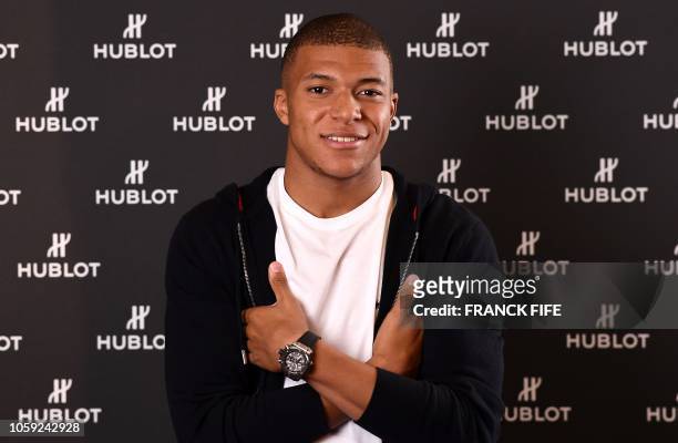 France's forward Kylian MBappe poses during a photo session after an interview with AFP in which he announced the formalization of his Ambassadorship...