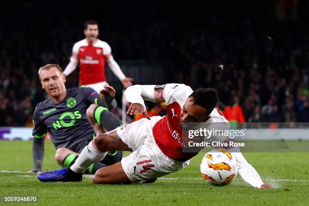 Pierre-Emerick Aubameyang of Arsenal is fouled by Jeremy Mathieu of Sporting CP who is sent off during the UEFA Europa League Group E match between...