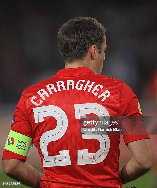 Jamie Carragher of Liverpool shows his support for the Unite Against Racism campaign ahead of the UEFA Europa League match between SSC Napoli and...