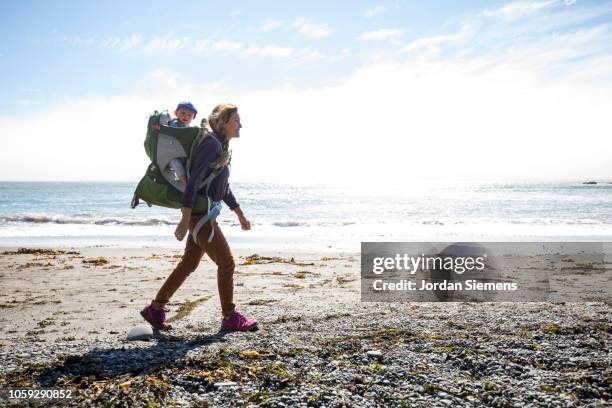 a mom and son on a hike. - baby carrier outside bildbanksfoton och bilder