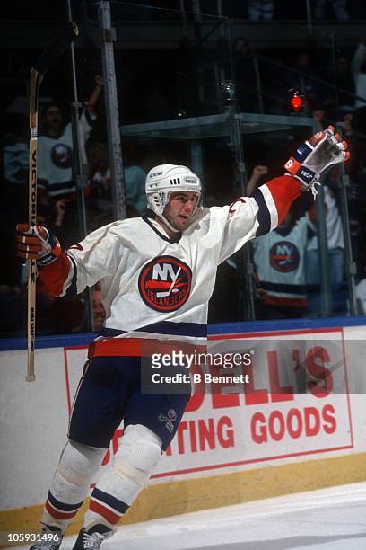Pierre Turgeon of the New York Islanders celebrates a goal during an NHL game circa 1992 at the Nassau Coliseum in Uniondale, New York.