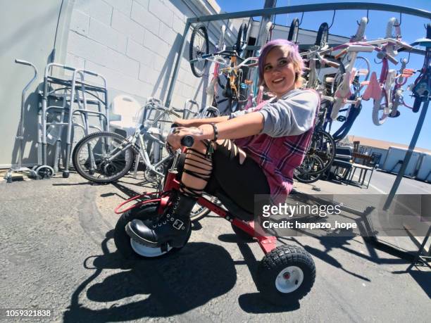 cool girl sitting on a tricycle. - skimpy girls stock pictures, royalty-free photos & images