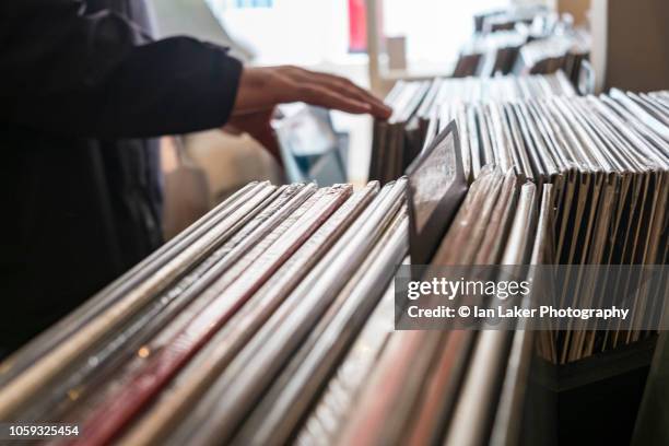 browsing vinyl lps in record store - magasin musique photos et images de collection