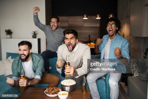 friends watching sport on tv. - match sport stock pictures, royalty-free photos & images