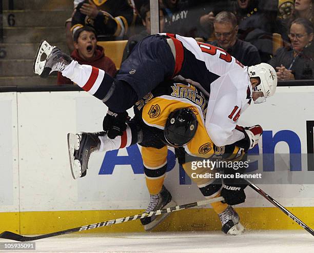 Eric Fehr of the Washington Capitals flips over Johnny Boychuk of the Boston Bruins at the TD Garden on October 21, 2010 in Boston, Massachusetts.