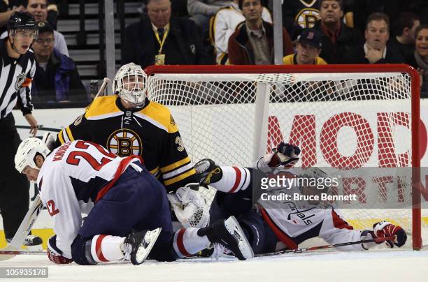 Mike Knuble and Alex Ovechkin of the Washington Capitals crash into Tim Thomas of the Boston Bruins at the TD Garden on October 21, 2010 in Boston,...