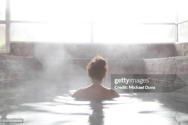 woman in an outdoor bath with steam - spa treatment stock pictures, royalty-free photos & images