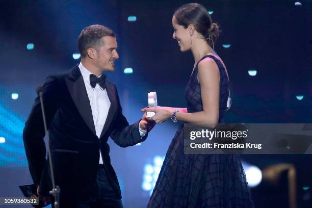 Orlando Bloom and Ana Schweinsteiger are seen on stage during the GQ Men of the Year Award show at Komische Oper on November 8, 2018 in Berlin,...