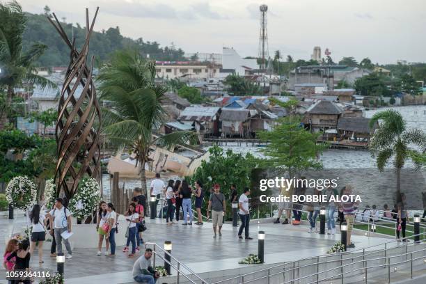 In this photo taken on November 8 residents stand at the memorial for victims of Super Typhoon Haiyan during the fifth anniversary of the typhoon in...