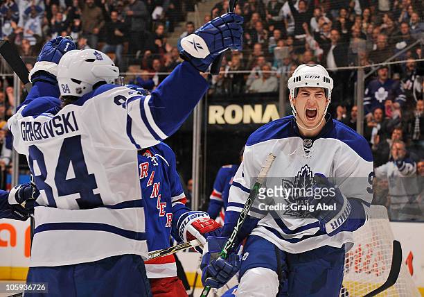 Mikhail Grabovski and Colby Armstrong of the Toronto Maple Leafs celebrate a third period goal against the New York Rangers during game action...
