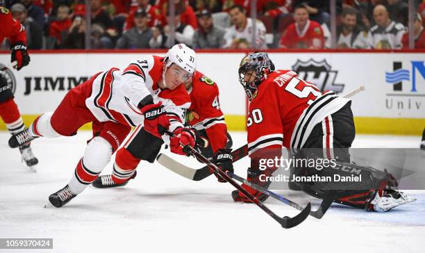 Andrei Svechnikov of the Carolina Hurricanes pushes the puck past Corey Crawford of the Chicago Blackhawks to score a first period goal at the United...