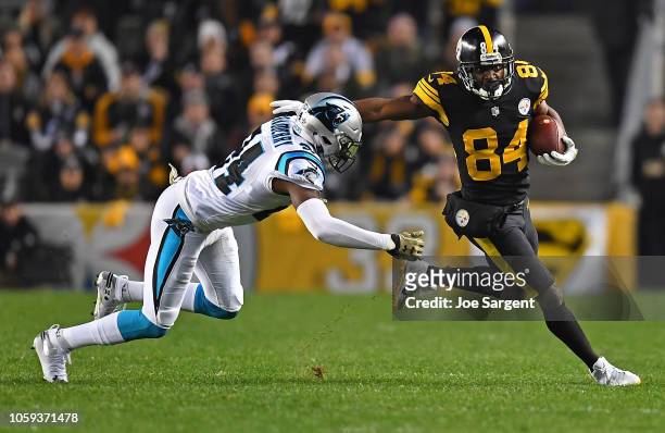 Antonio Brown of the Pittsburgh Steelers runs up field as James Bradberry of the Carolina Panthers attempts a tackle during the first half in the...
