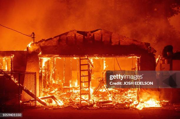 Home burns as the Camp fire tears through Paradise, California on November 8, 2018. - More than 18,000 acres have been scorched in a matter of hours...