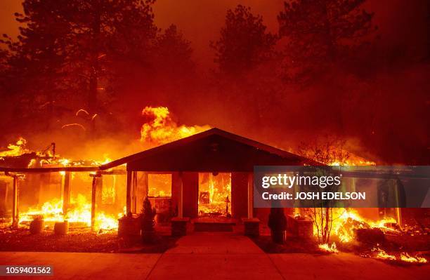 Home burns during the Camp fire in Paradise, California on November 8, 2018. - More than 18,000 acres have been scorched in a matter of hours burning...
