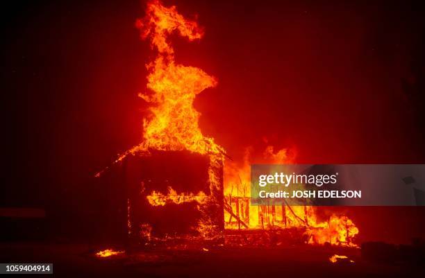 Home burns as the Camp fire tears through Paradise, California on November 8, 2018. - More than 18,000 acres have been scorched in a matter of hours...