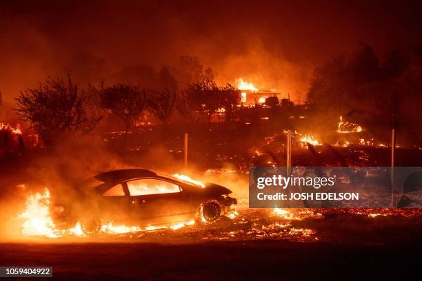 Vehicles and homes burn as the Camp fire tears through Paradise, California on November 8, 2018. More than 18,000 acres have been scorched in a...